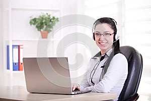 Pretty woman working as operator in office