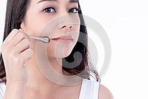 Pretty woman is 25 years old, She is using stainless steel bars Massage the skin around the lips