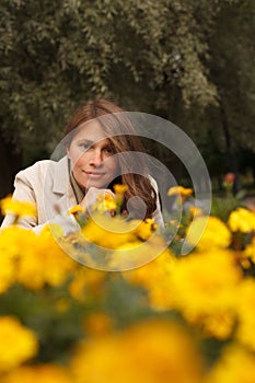 Pretty woman in yellow flowers outdoor