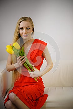 Pretty woman with yellow tulips bunch