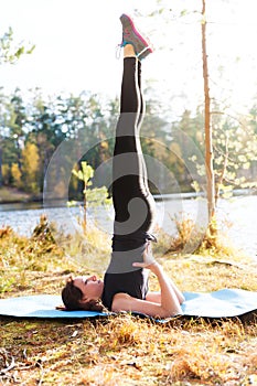 Pretty woman in yoga Salamba Sarvangasana - shoulderstand pose