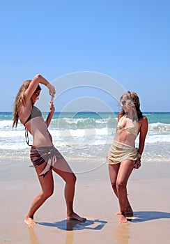 Pretty women playing on beach