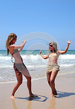 Pretty women playing on beach