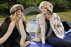 Pretty women wearing winter fur coats photo