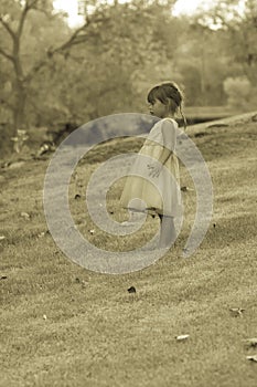 Pretty 3 1/2 year old Asian-Caucasian girl standing on grass