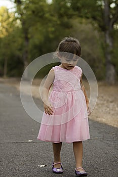 Pretty 3 1/2 year old Asian-Caucasian girl standing on grass