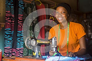 pretty young african woman who is a tailor smiling