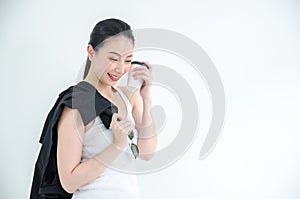 Pretty young asian business woman holding a cup of coffee and black tshirts. Isolated Studio portrait on white background