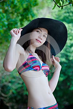 Pretty Young Asian woman in bikini relaxing on the beach