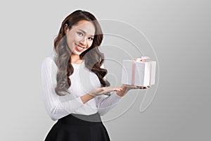 Pretty young asian woman holding gift box