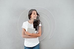 Pretty young asian woman holding tablet computer