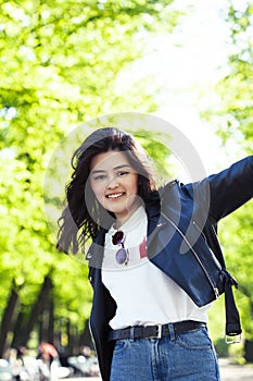 Pretty young asian woman smiling cheerful in green park on summer sunny day, lifestyle people concept