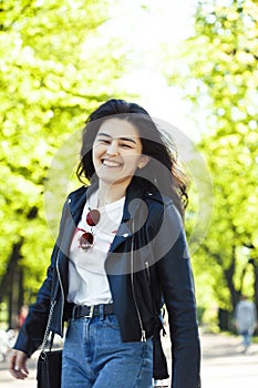 Pretty young asian woman smiling cheerful in green park on summer sunny day, lifestyle people concept