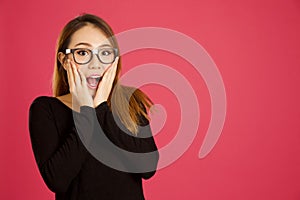 Pretty young asian woman in the studio looking shocked