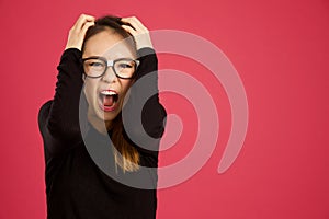 Pretty young asian woman in the studio screaming at camera