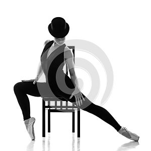 Pretty young ballerina sitting on the chair. photo