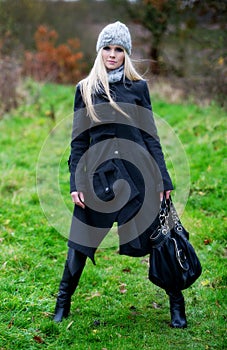 Pretty young blonde female posing outdoors