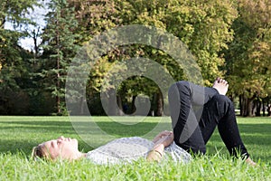 Young blonde girl lye on grass relax time and cheerful woman