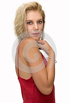 Pretty young blonde woman with a red dress on white background
