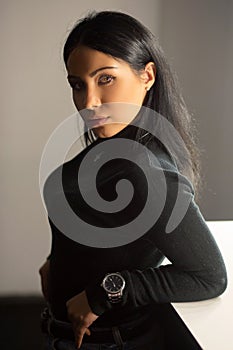 Pretty young brunette posing in a studio