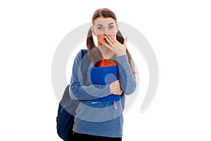 Pretty young brunette student girl with blue backpack isolated on white background