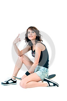 Pretty young brunette woman with a skateboard