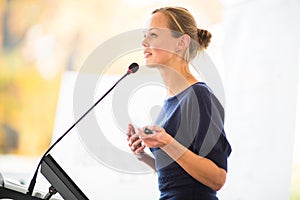 Pretty, young business woman giving a presentation