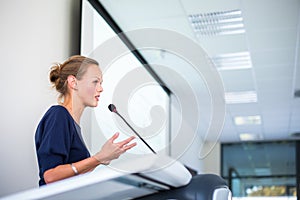 Pretty, young business woman giving a presentation