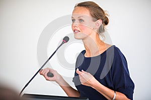 Pretty, young business woman giving a presentation