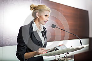 Pretty, young business woman giving a presentation