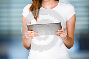 Pretty, young businesswoman/colle ge student using her tablet photo