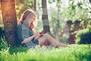 Pretty young caucasian woman sitting outside