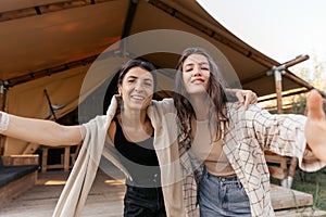 Pretty young caucasian women posing looking at camera standing near glamming.