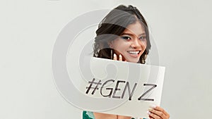 Pretty young excited woman holding  GENZ text in board