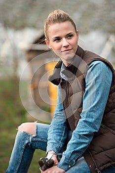 Pretty young farmer woman with cutting branches tool on spring Farmer`s garden