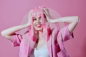 Pretty young female attractive look pink wig stylish clothes pink background unaltered