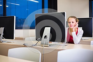Pretty, young female college student using a desktop computer