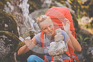 Pretty, young female hiker walking in high mountains