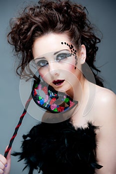 Pretty young female with mask and beauriful makeup