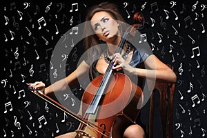 Pretty young female musician playing the cello