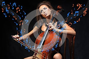 Pretty young female musician playing the cello