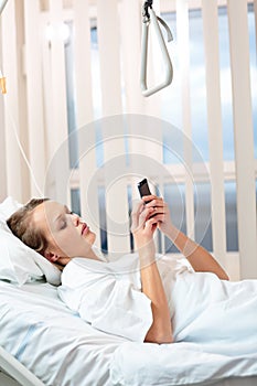 Pretty, young, female patient in a modern hospital room