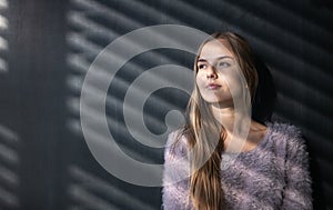 Pretty, young female student in front of a blackboard