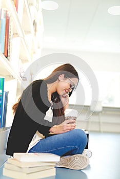 Pretty young female student sitting studying