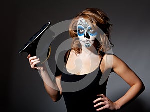 Pretty young female in sugar skull make up