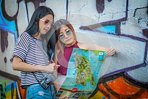 The Pretty young female tourist studying a map. with abstract gr