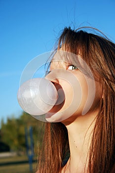 Pretty young girl blowing bubble gum