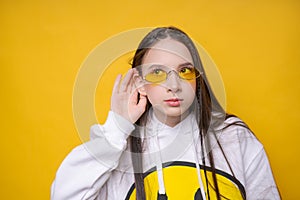 Pretty young girl brunette girl in casual white plumpness, glasses posing