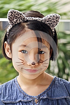 Pretty young girl with cat face paint