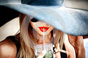 Pretty young girl drink cold coctail outdoor in beach cafe